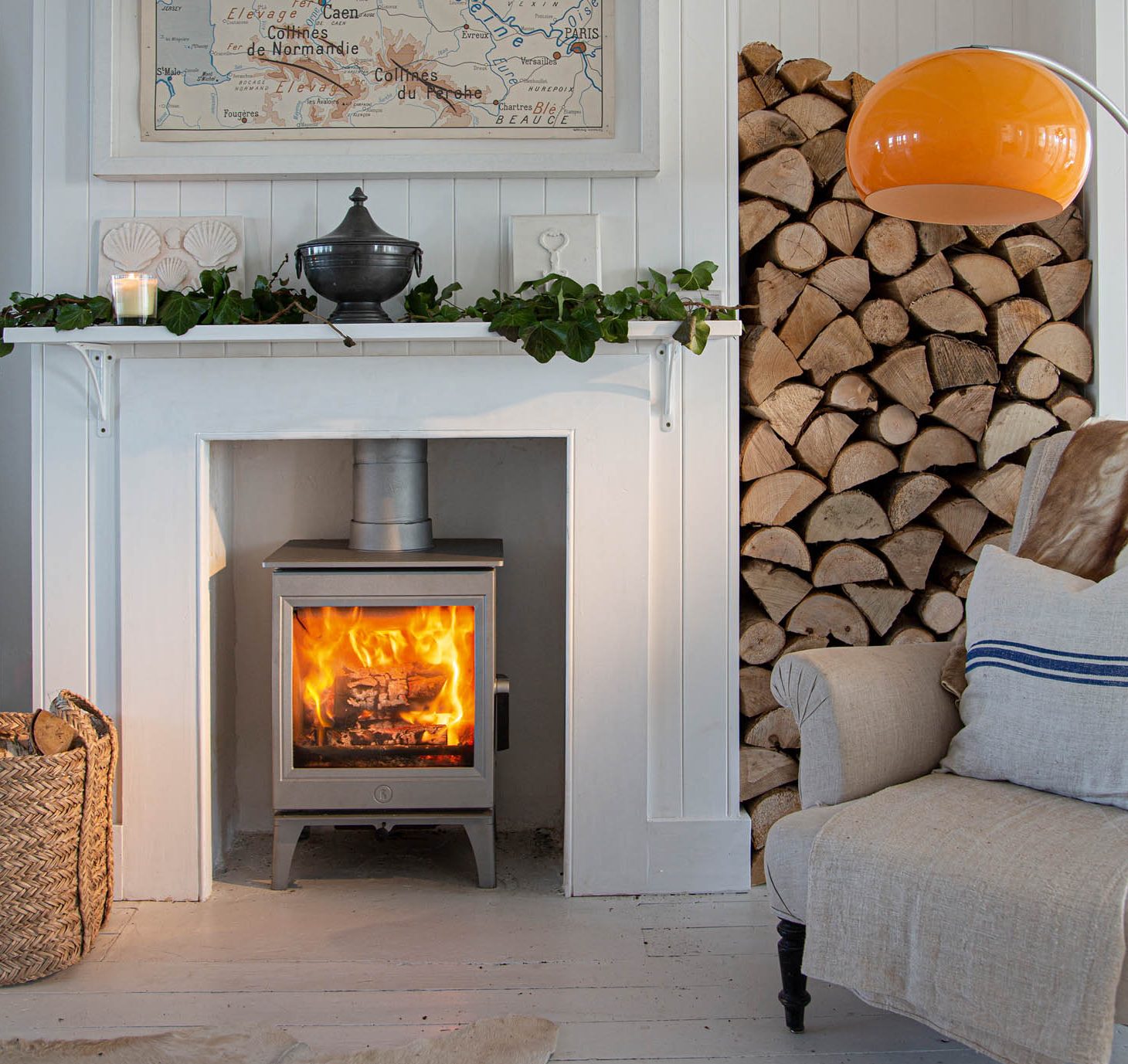 Wood burning stoves inside a fireplace with log storage for a cosy Leicester living room